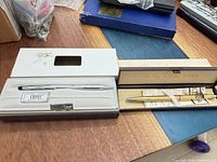 Both pens in their respective cases on table