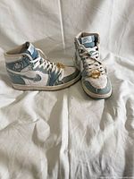 Full view of both sneakers showing overall design and condition