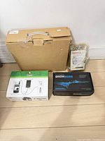 All four items: Atlas 9 box, Grow Boss box, Thimmax controller package, large cardboard box housing LED grow light