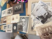 Overview of entire lot showing mounted photographs spread on table