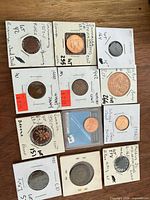 Overview of eleven coin holders on wood surface