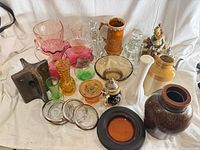Group shot of all glassware, ceramic items, metal coasters and figurine