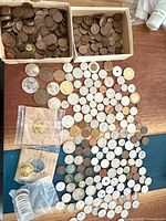 Overall view of two boxes of cents and spread of assorted coins