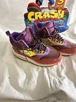 Both sneakers angled top view showing overall design and size comparison