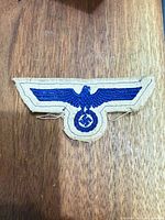 Front view of tan cloth eagle insignia