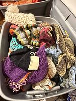 Top view of tote showing variety of crochet items in multiple colours and patterns