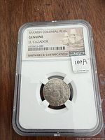 Front view of NGC holder showing Spanish Colonial Real coin and certification label