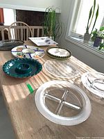 All eight platters on table showing variety of sizes, shapes and materials