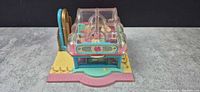 Front view of Polly Pocket café playset showing clear roof and façade
