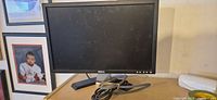 Front view of Dell E207WFPc monitor on stand with coiled VGA cable