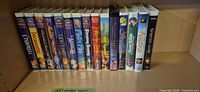 Full row of 15 Disney VHS tapes on shelf