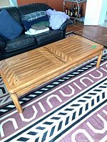 Top view of rectangular oak-veneer coffee table showing parquet chevron pattern and overall condition