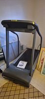 Full view of PaceMaster treadmill with manual on belt