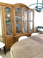 Front perspective of china cabinet showing full height and upper glass display