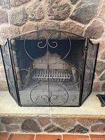 front view of fireplace screen showing scroll design and mesh