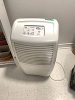 Full view of Whirlpool dehumidifier showing front grille and power cord