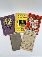 Five catalogue covers laid out