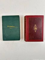 Front covers of both books showing cloth colours and gilt details