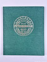 Front cover showing title emblem on green cloth