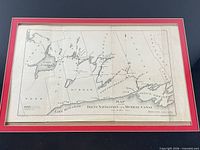 Front view of framed 1904 map with red and black matting