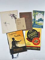 Six catalogues laid out showing covers and titles