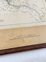 Front view showing map details and presentation inscription on mat