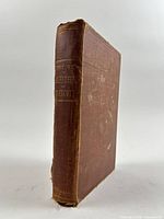 Front spine and cover of brown cloth hardcover book