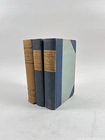 Three hardcover limited edition books standing upright