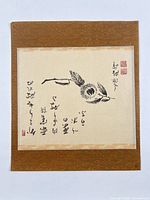 Full view of mounted scroll showing artwork and brown silk border