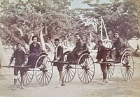 Close view of the hand-coloured albumen photograph showing rickshaw drivers and passengers