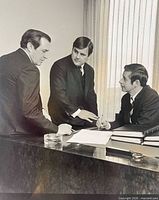 Front view of the photograph showing three businessmen and overall image quality