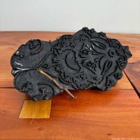 Front view showing carved relief pattern and overall shape