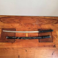 Entire sword unsheathed with scabbard shown