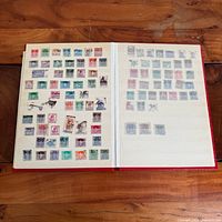 Album open showing two filled pages of assorted stamps