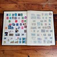 Open album showing two pages of assorted Canadian stamps
