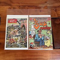 Both Zap Comix issues in protective sleeves side by side