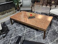 Full view of coffee table showing red granite top and metal frame