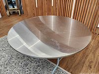 Top view of stainless steel round table surface showing overall condition and finish