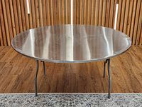 Full view of round stainless steel folding table