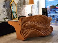 Front angled view showing sculptural wood ribs and ceramic stone top