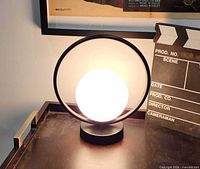 Lamp illuminated showing circular frame and glowing globe