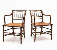 Front view of both Regency faux bamboo armchairs showing paint, rush seats and overall form