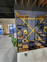 Front angled view of tall iron and pine bookcase