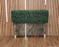 Front view of rectangular boxwood hedge on wooden feet