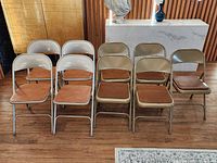 Front view of all nine folding chairs showing color mix and condition