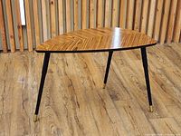 Oblique view of table showing top pattern, legs and caps