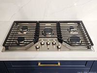 Full top view showing complete cooktop with five burners and control knobs
