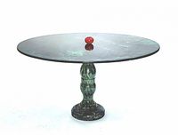Full view of round green marble table on pedestal base