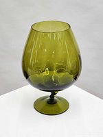 Front view of olive green optic glass snifter vase on pedestal