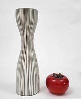 Full view of ceramic hourglass vase with scale object